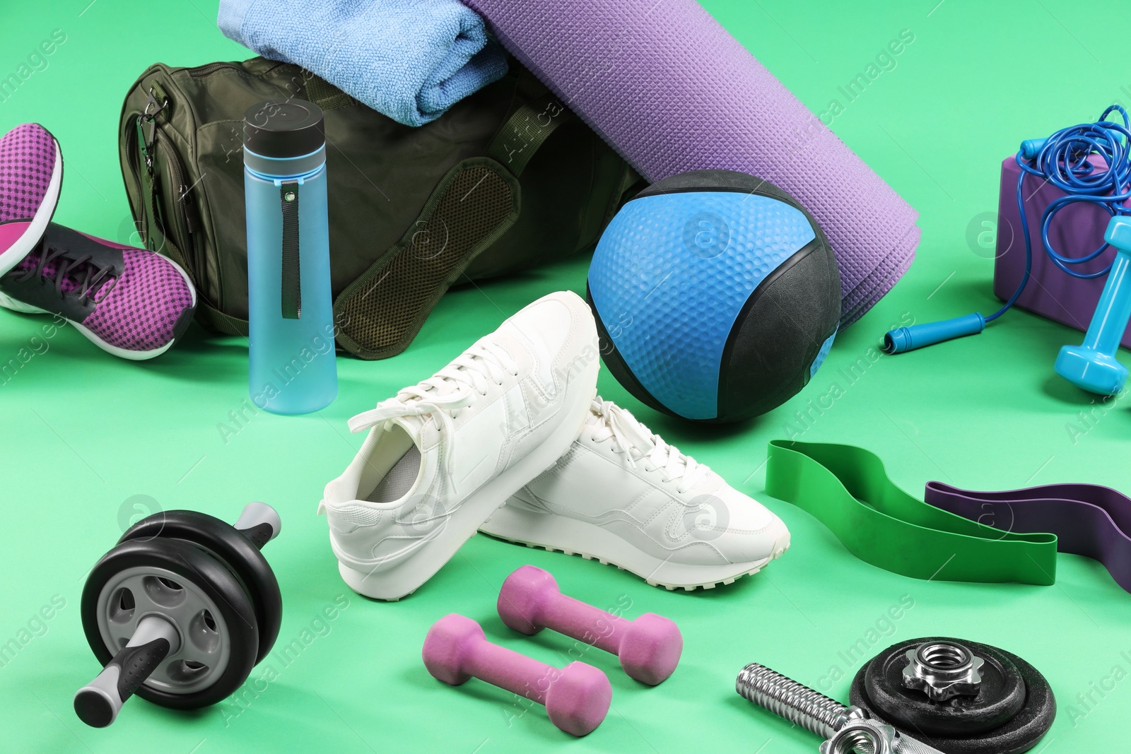 Photo of Many different sports equipment on green background