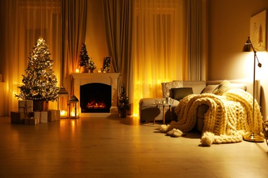 Photo of Stylish living room interior with beautiful fireplace, Christmas tree