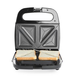 Modern sandwich maker with bread slices on white background