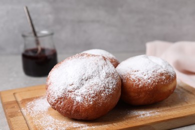 Delicious sweet buns on table against gray background