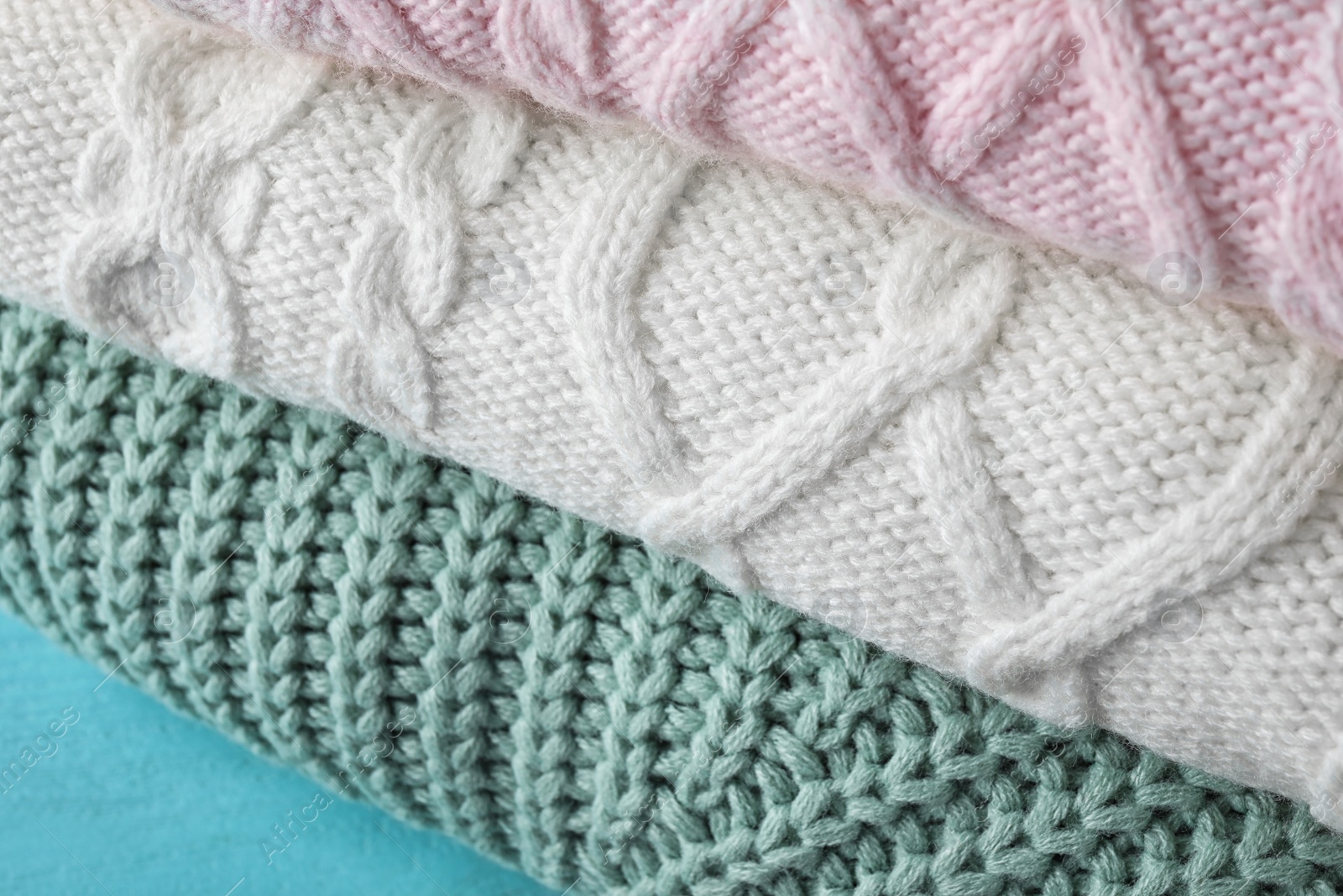 Image of Stack of folded warm sweaters, closeup view