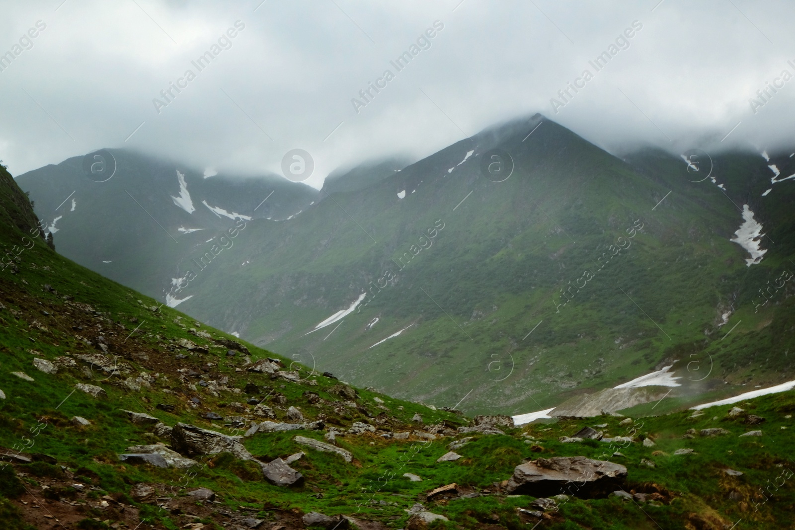 Photo of Picturesque view of beautiful foggy mountains and cloudy sky