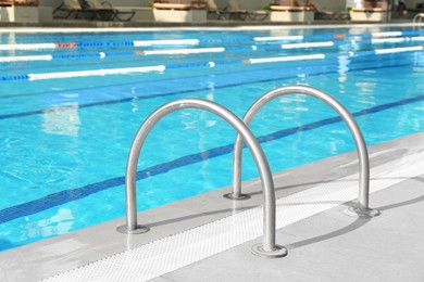 Photo of Ladder with handrails in outdoor swimming pool