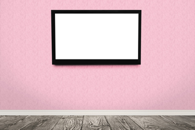 Modern TV on pink wall in room. Space for design