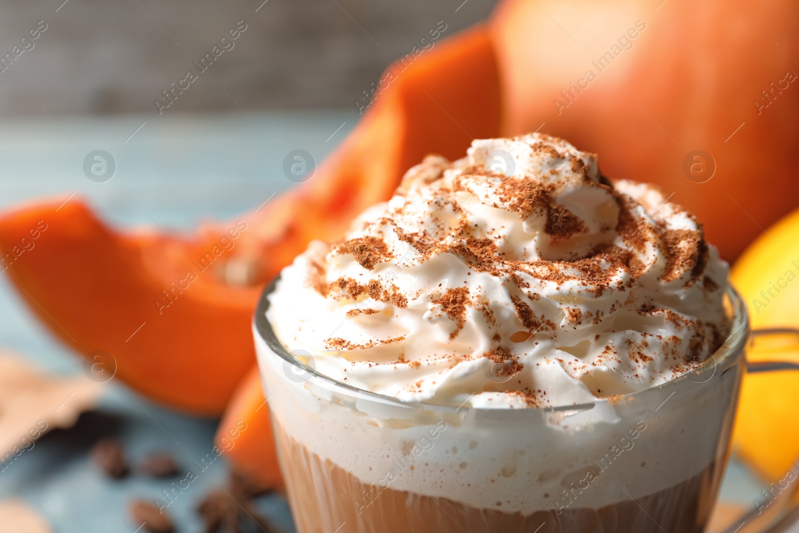 Photo of Glass cup with tasty pumpkin spice latte, closeup