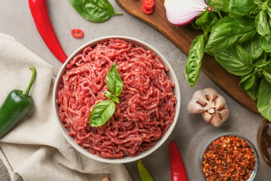 Flat lay composition with fresh raw minced meat on light table