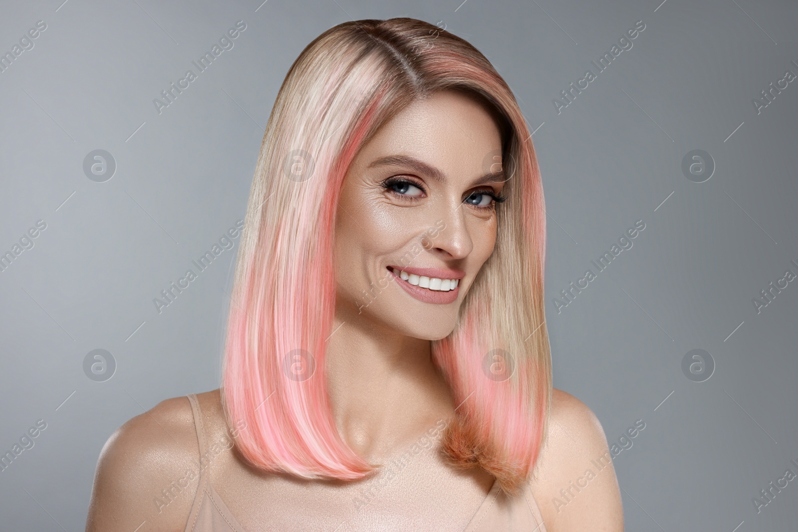 Image of Hair styling. Gorgeous woman with colorful hair on grey background