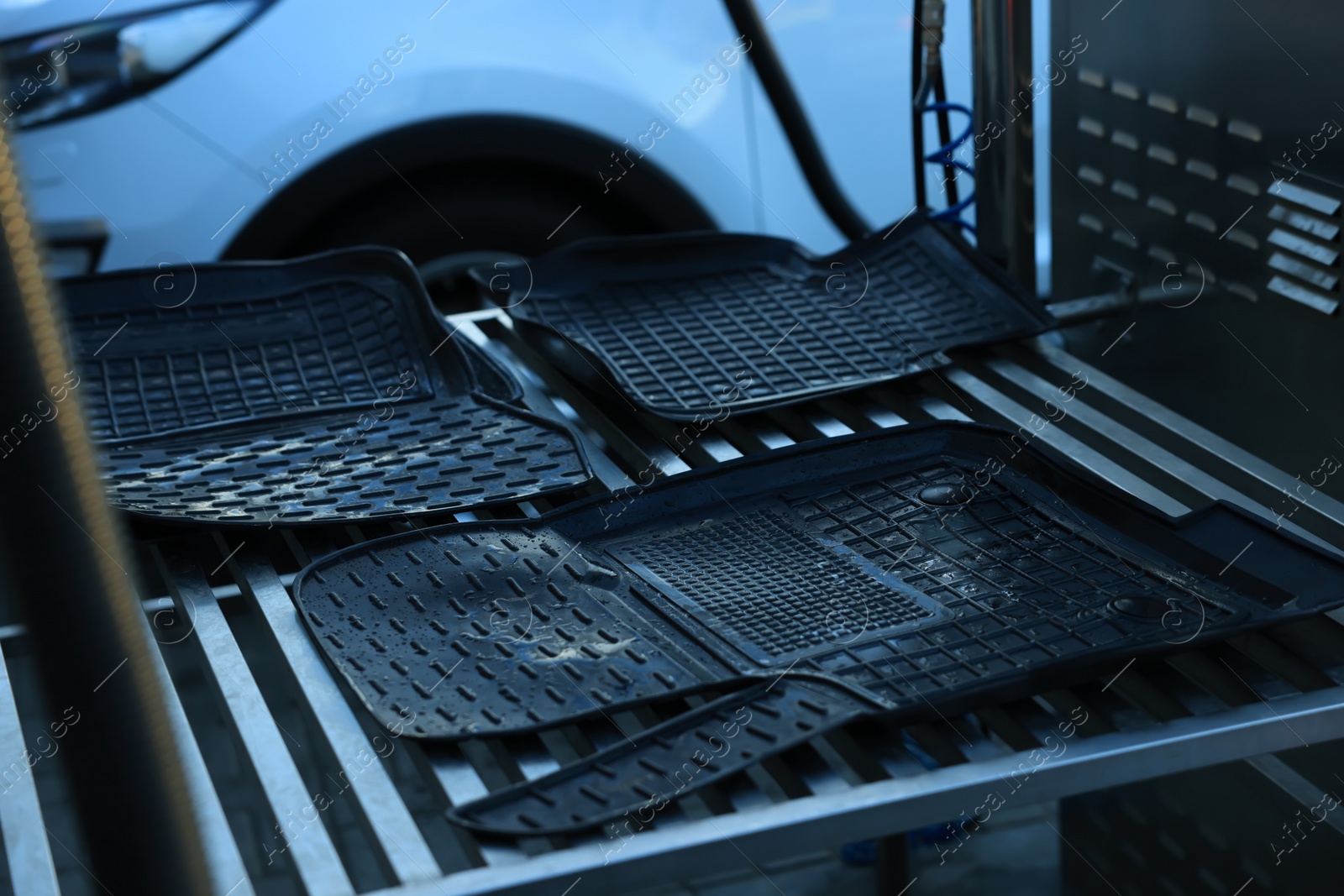 Photo of Wet auto mats at car wash, closeup
