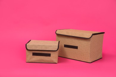 Photo of Two textile storage cases on pink background. Space for text