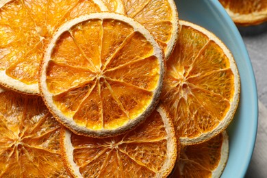 Many dry orange slices on grey table, top view