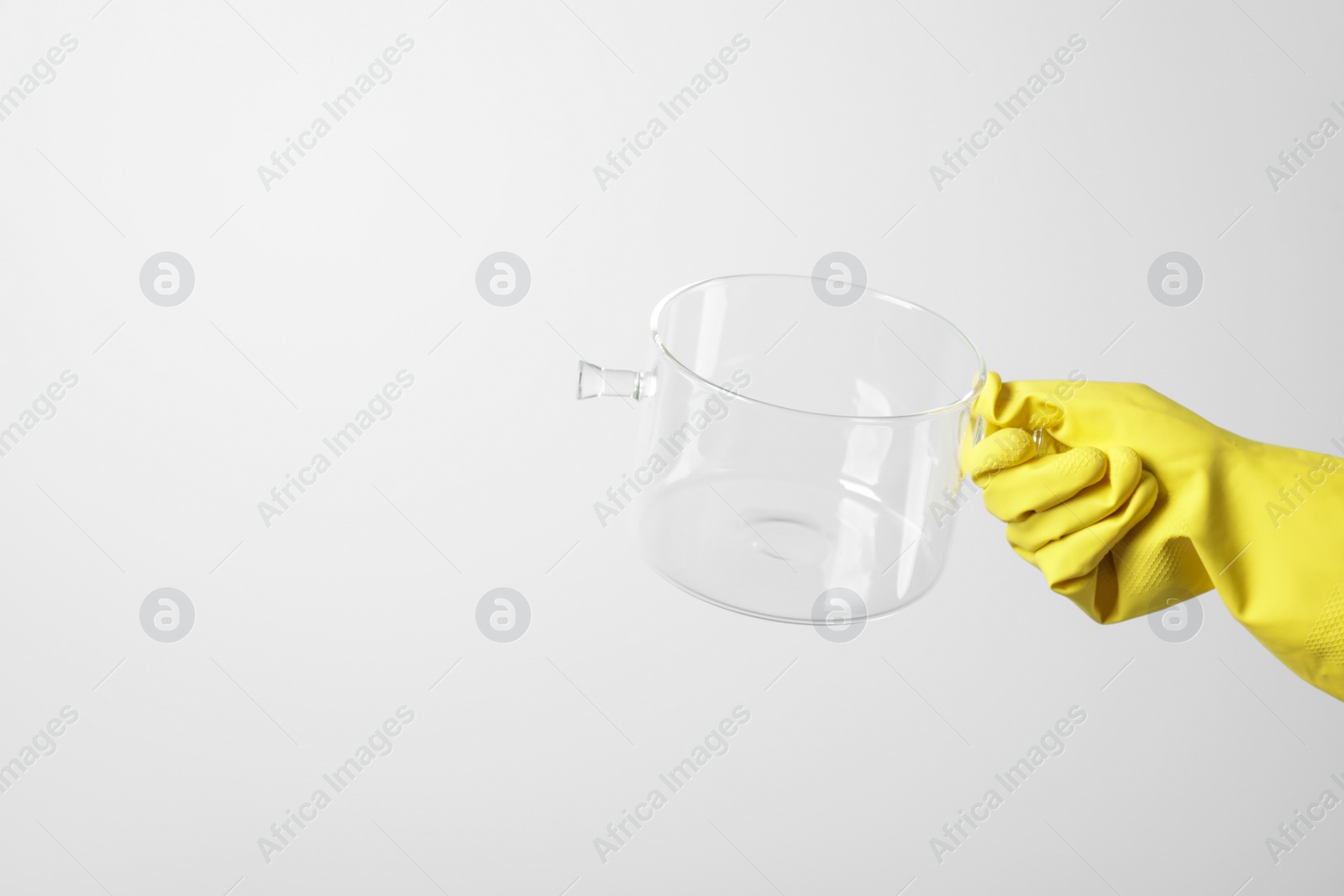 Photo of Woman holding glass empty pot on white background, closeup. Space for text