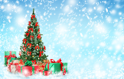 Image of Beautiful Christmas tree with gifts under snowfall, space for text
