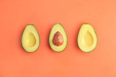 Flat lay composition with ripe avocados on color background