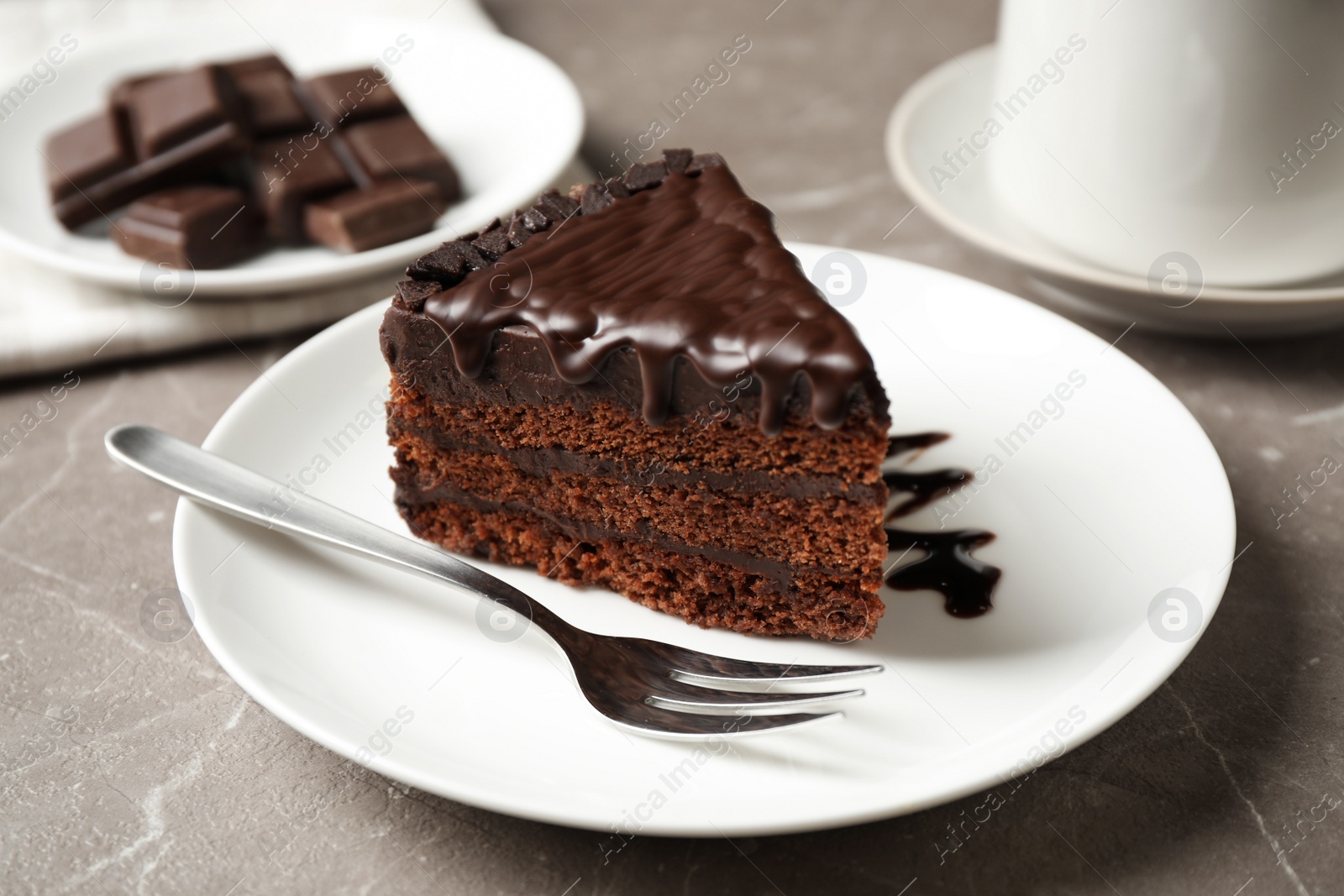 Photo of Tasty chocolate cake served on grey table