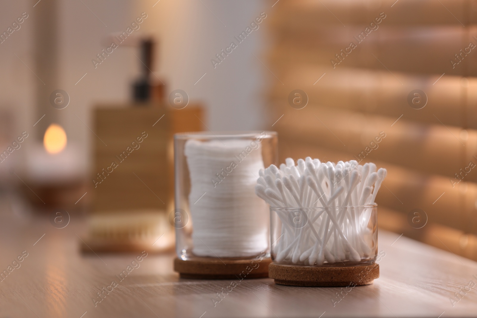 Photo of Cotton buds and pads on wooden surface indoors