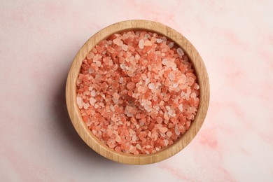 Photo of Aromatic sea salt on pink marble table, top view