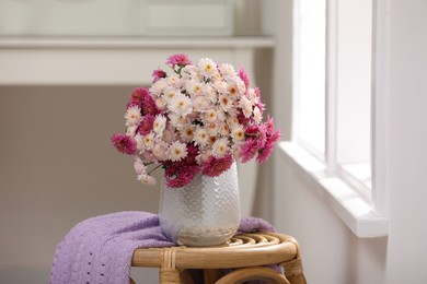 Photo of Beautiful bouquet on wooden stand near window indoors