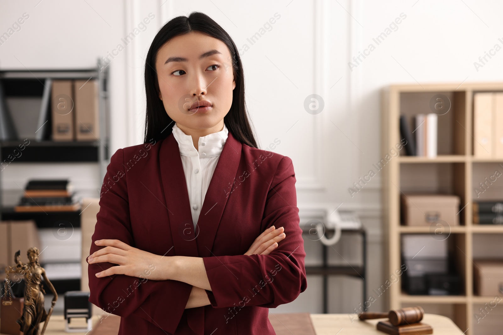 Photo of Portrait of notary with crossed arms in office. Space for text