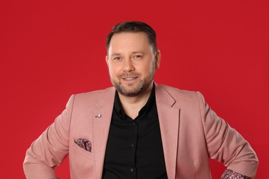 Photo of Portrait of happy mature man on red background