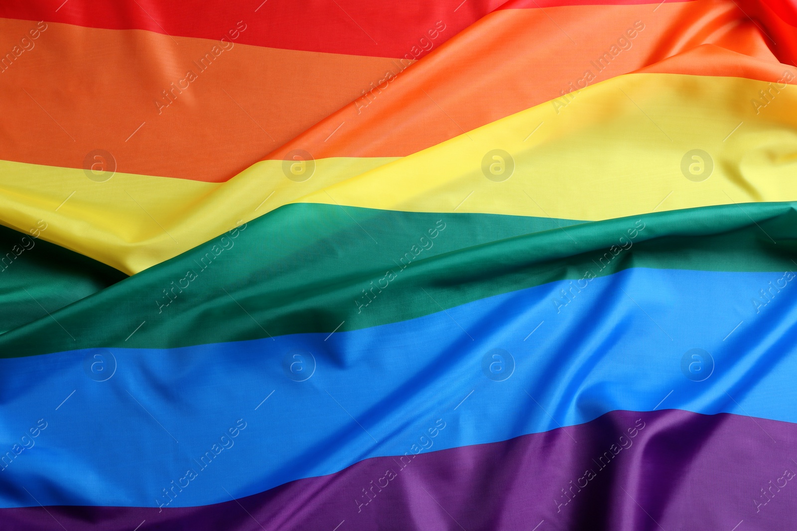 Photo of Bright rainbow gay flag as background. LGBT community