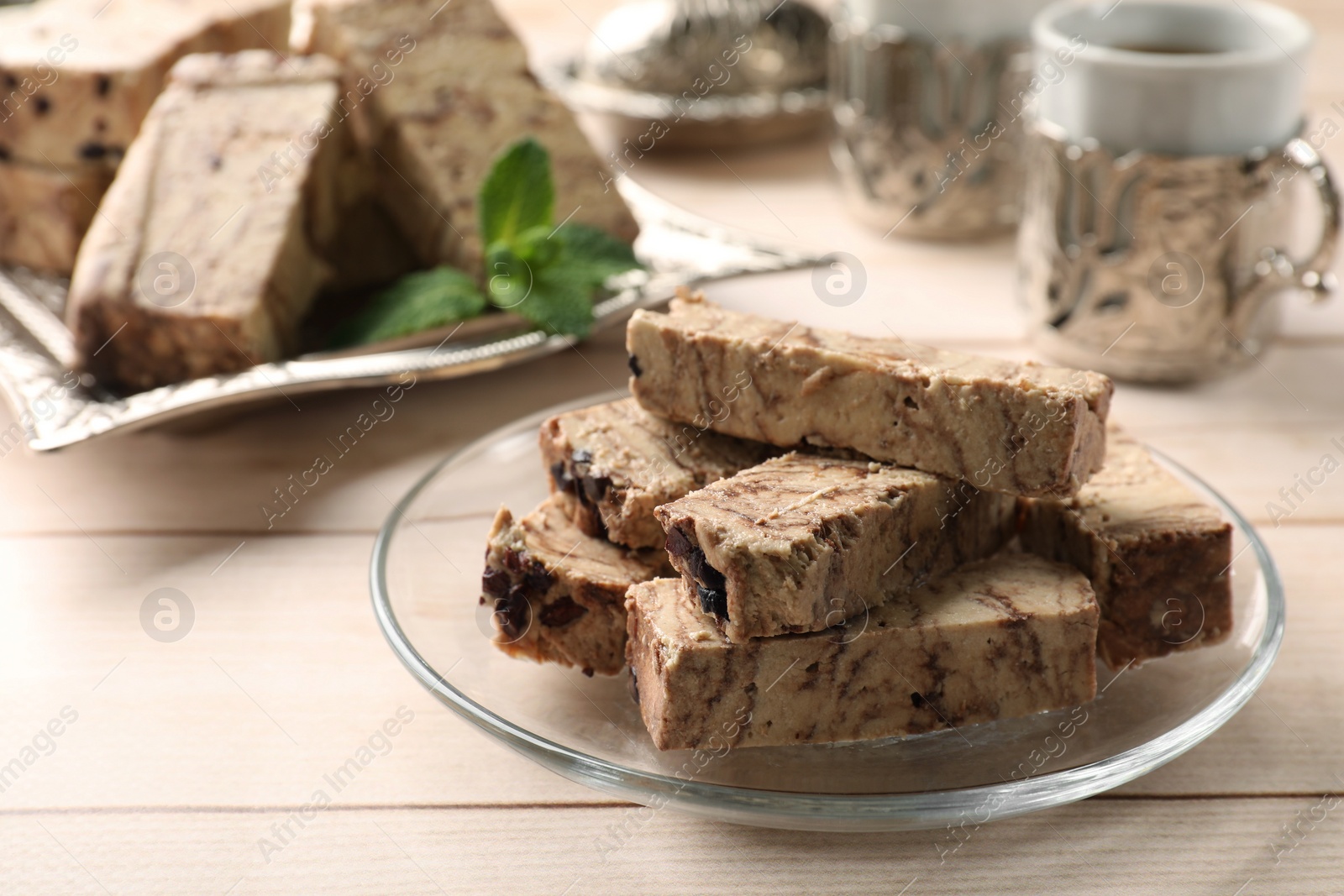 Photo of Tasty chocolate halva on wooden table, closeup