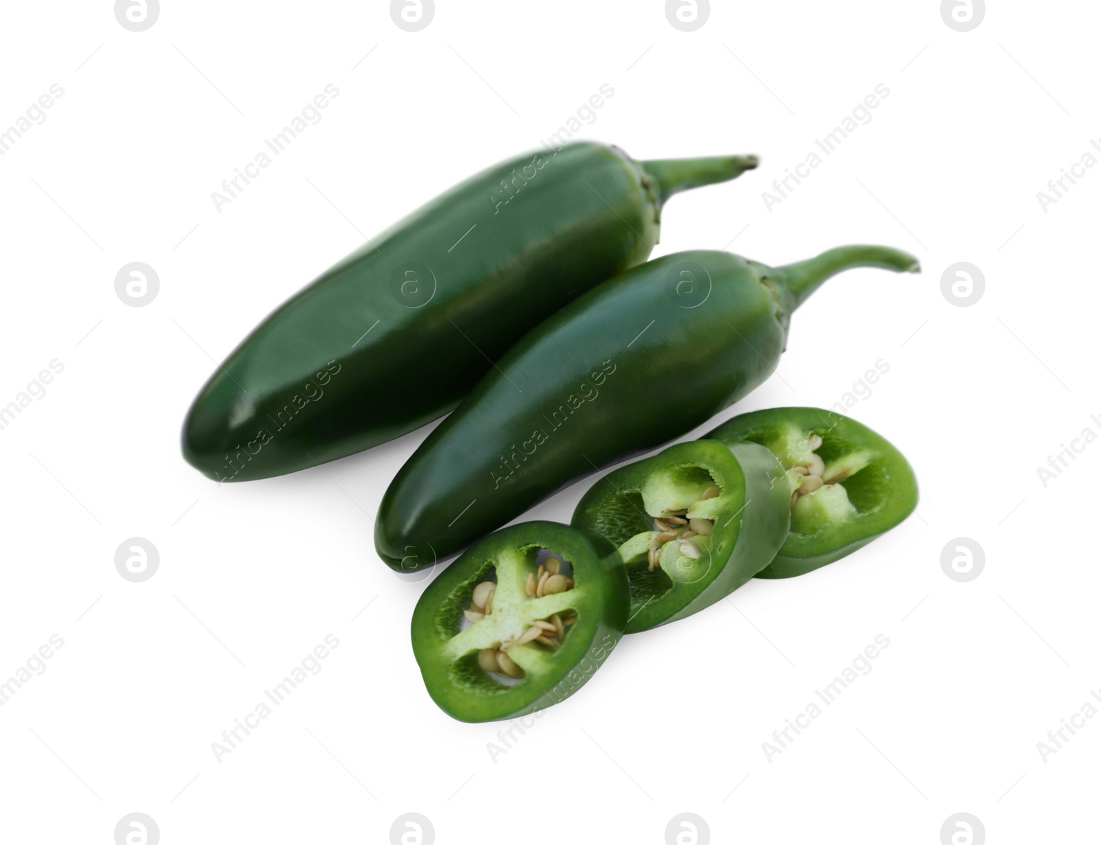 Photo of Whole and cut green hot chili peppers isolated on white, top view