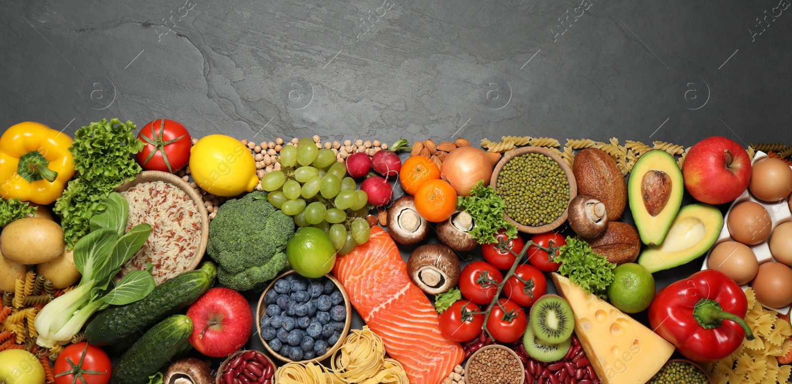 Photo of Different products on black table, top view with space for text. Healthy food and balanced diet