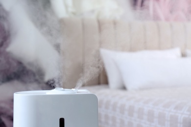 Photo of Modern air humidifier indoors, closeup. Space for text