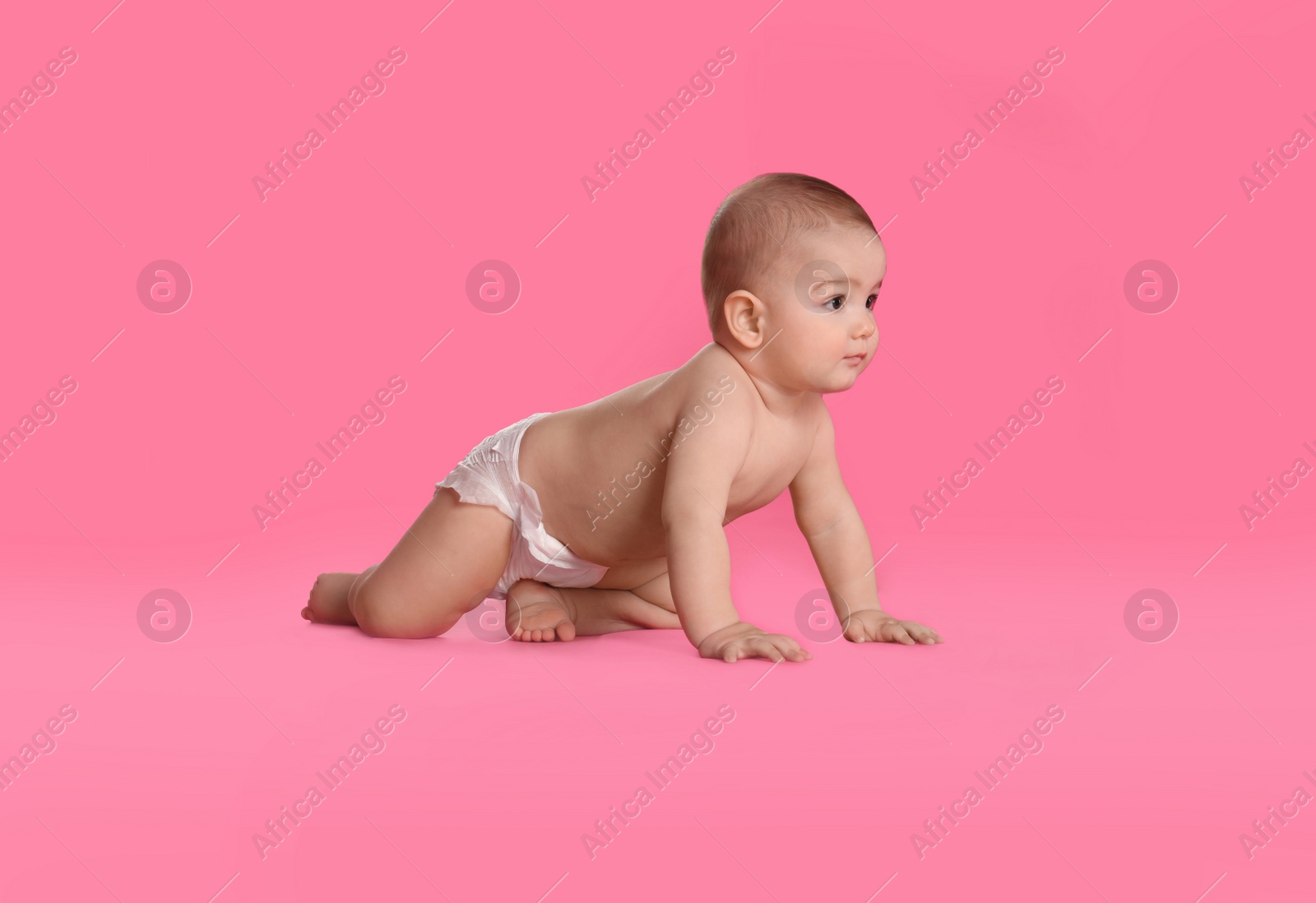 Photo of Cute little baby in diaper on pink background. Space for text
