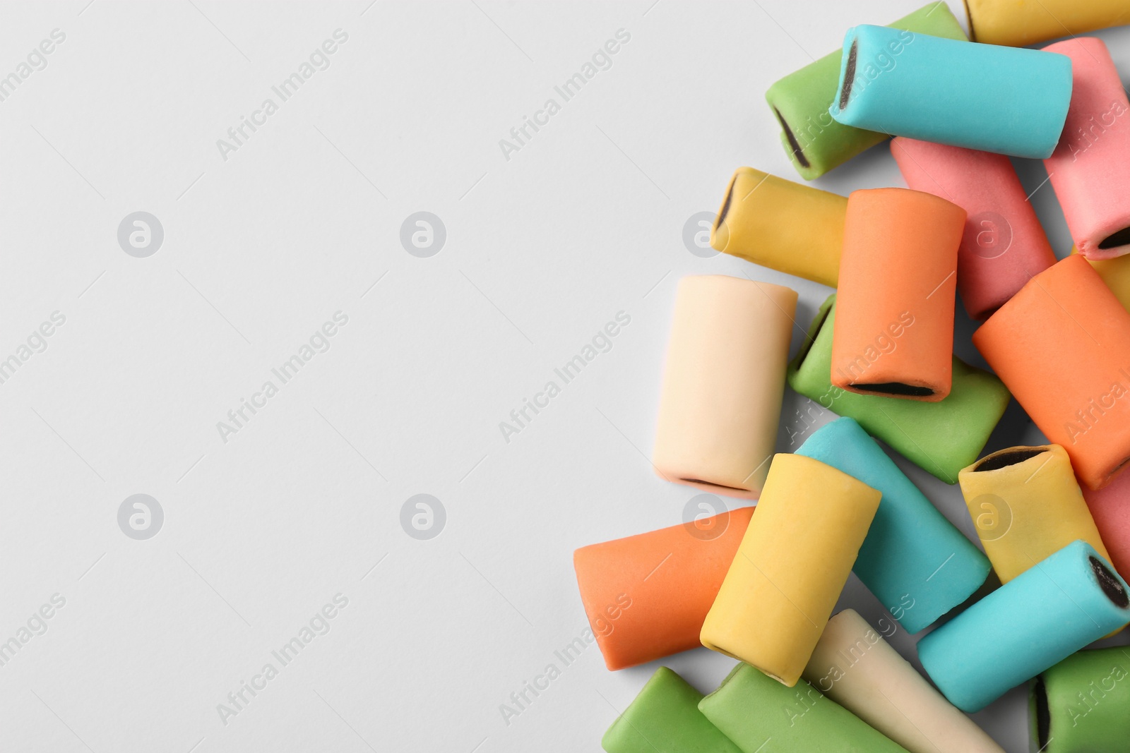 Photo of Tasty liquorice candies on light background, top view. Space for text