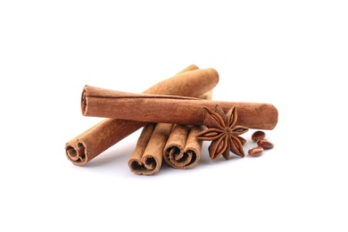 Aromatic cinnamon sticks and anise on white background