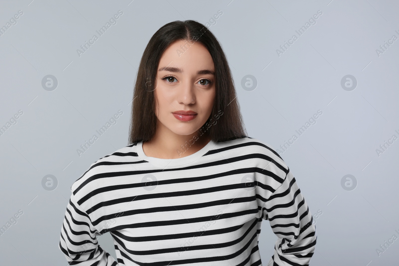 Photo of Portrait of beautiful young woman on light grey background