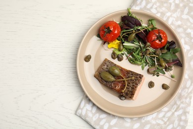 Photo of Tasty salmon with salad and capers on white wooden table, top view. Space for text