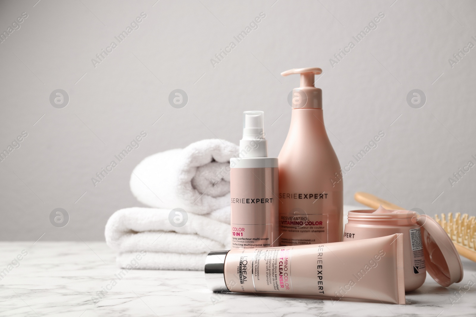 Photo of MYKOLAIV, UKRAINE - AUGUST 08, 2020: L'Oreal hair care cosmetic products on white marble table. Space for text