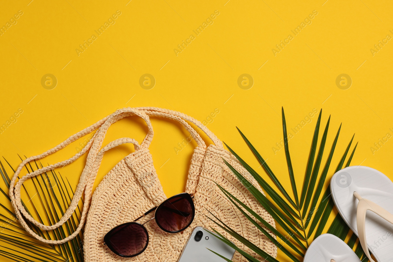 Photo of Flat lay composition with beach bag on orange background. Space for text