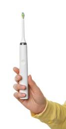 Photo of Woman holding electric toothbrush on white background, closeup