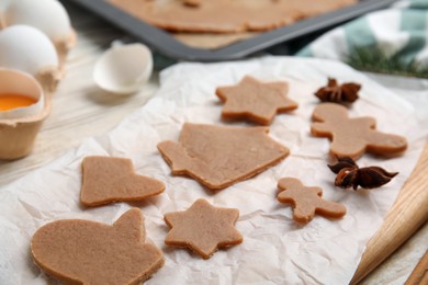 Photo of Raw Christmas cookies and anise on table, closeup