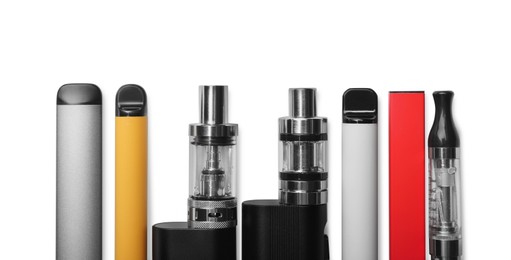Photo of Different electronic cigarettes on white background, top view