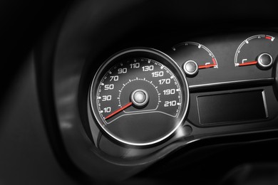 Photo of Modern speedometer with red arrow on dashboard of car