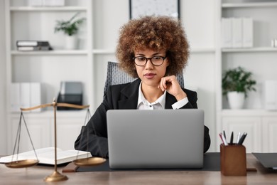 Photo of Notary using laptop at workplace in office