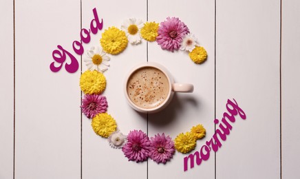 Good morning! Beautiful floral composition with cup of hot coffee on white wooden background, flat lay