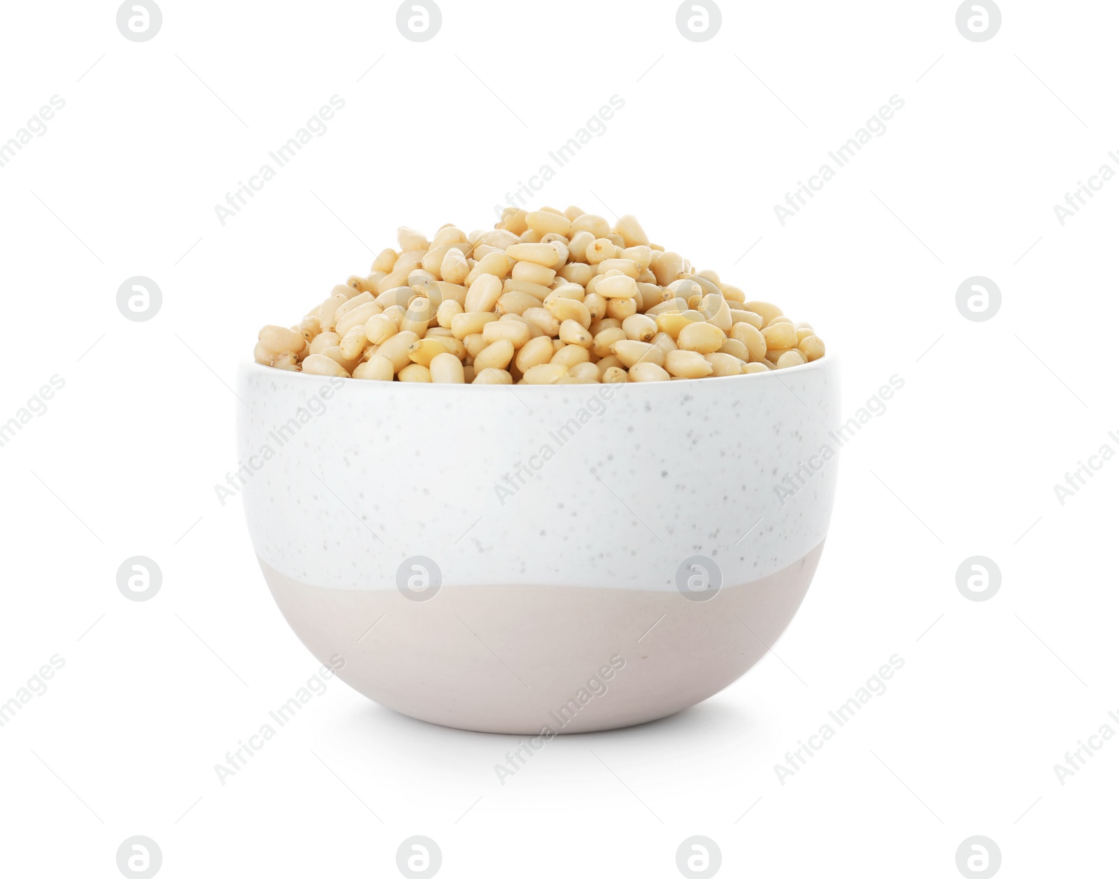 Photo of Bowl with pine nuts on white background