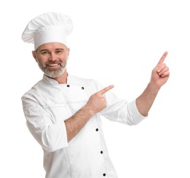 Photo of Happy chef in uniform pointing at something on white background