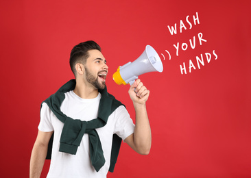 Image of Young man with megaphone on red background. Wash your hands to avoid coronavirus