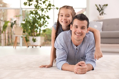 Photo of Father with cute child on floor at home. Happy family