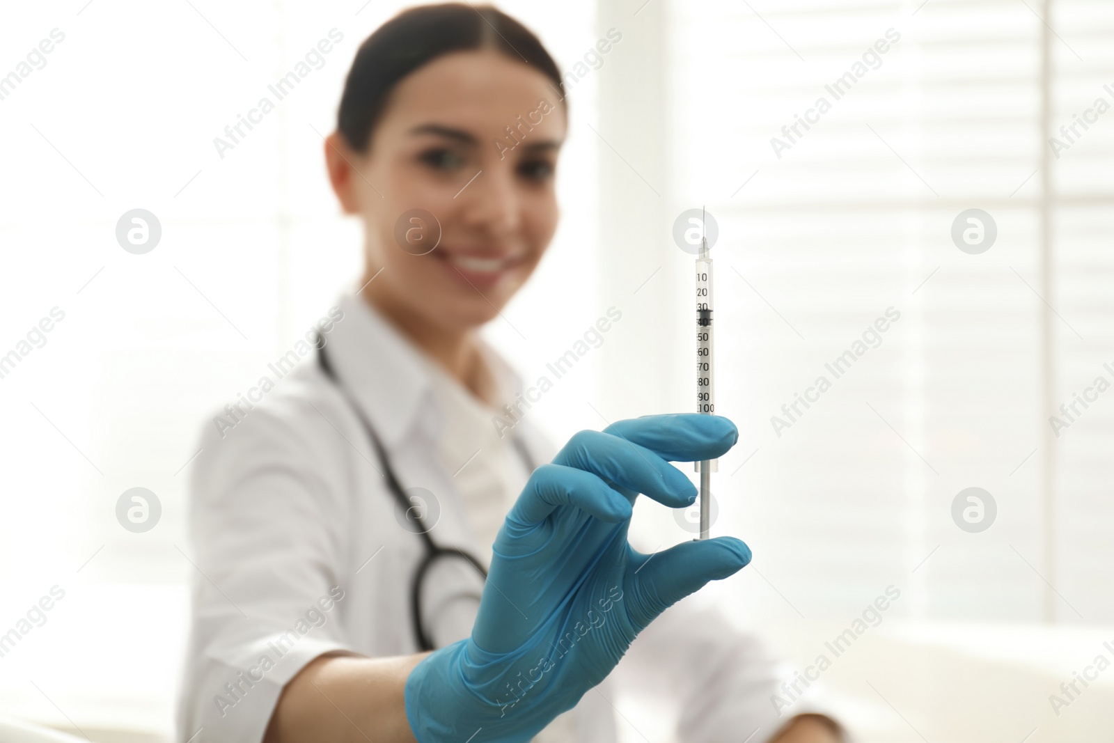Photo of Doctor in clinic, focus on hand with syringe. Vaccination day