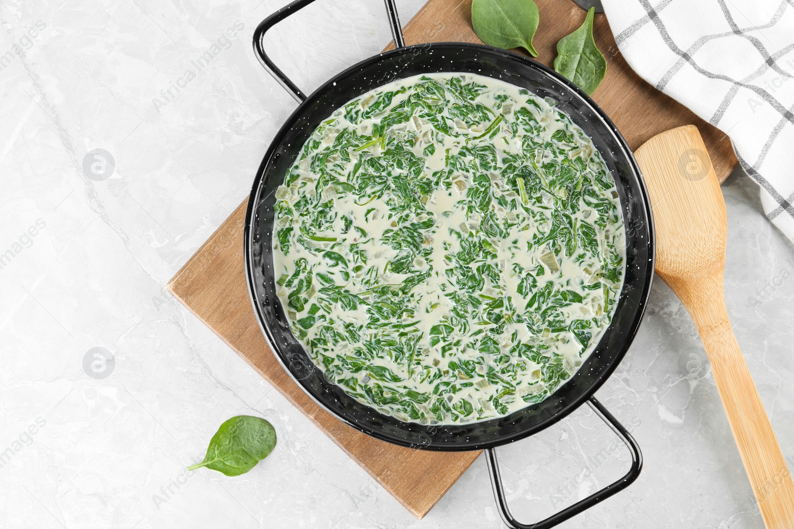 Photo of Tasty spinach dip on grey marble table, flat lay