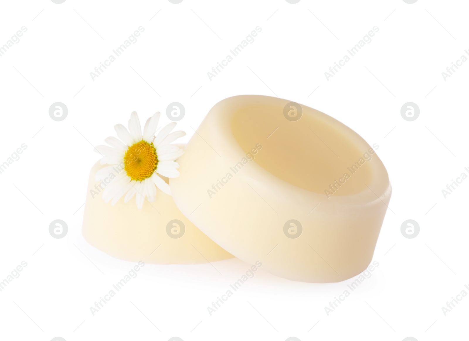 Photo of Solid shampoo bars and chamomile on white background. Hair care