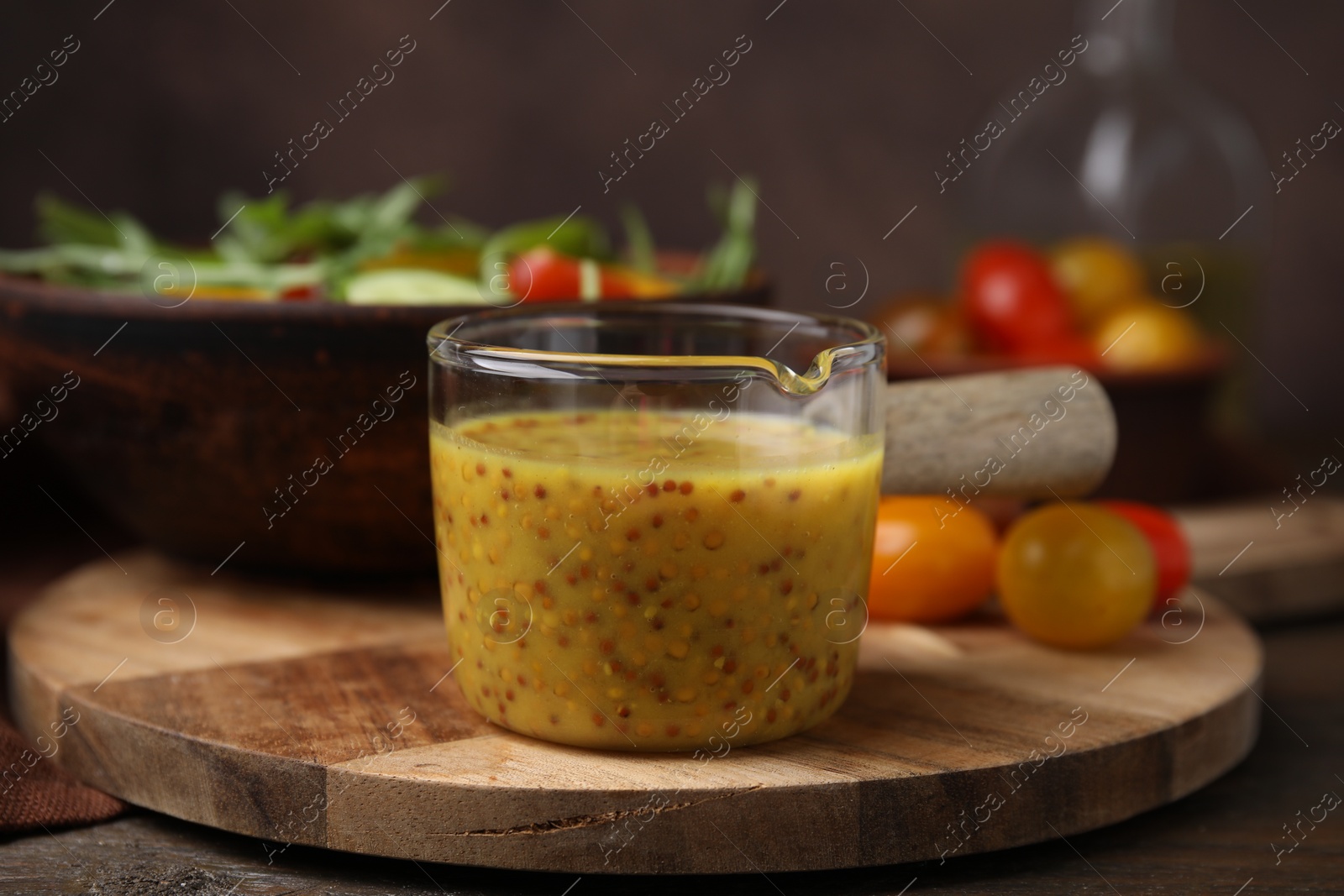 Photo of Tasty vinegar based sauce (Vinaigrette) on wooden table, closeup