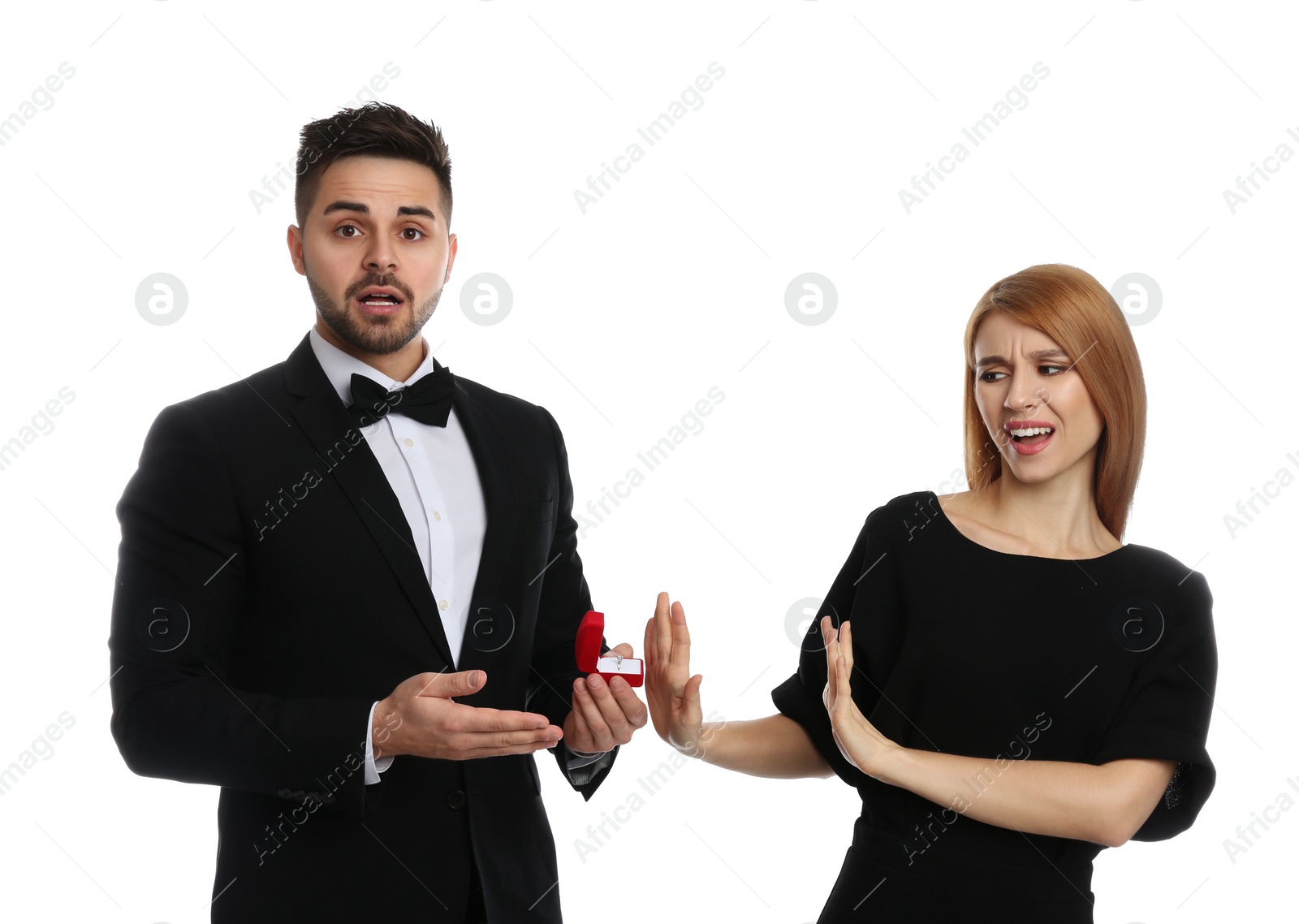 Photo of Young woman rejecting engagement ring from boyfriend on white background